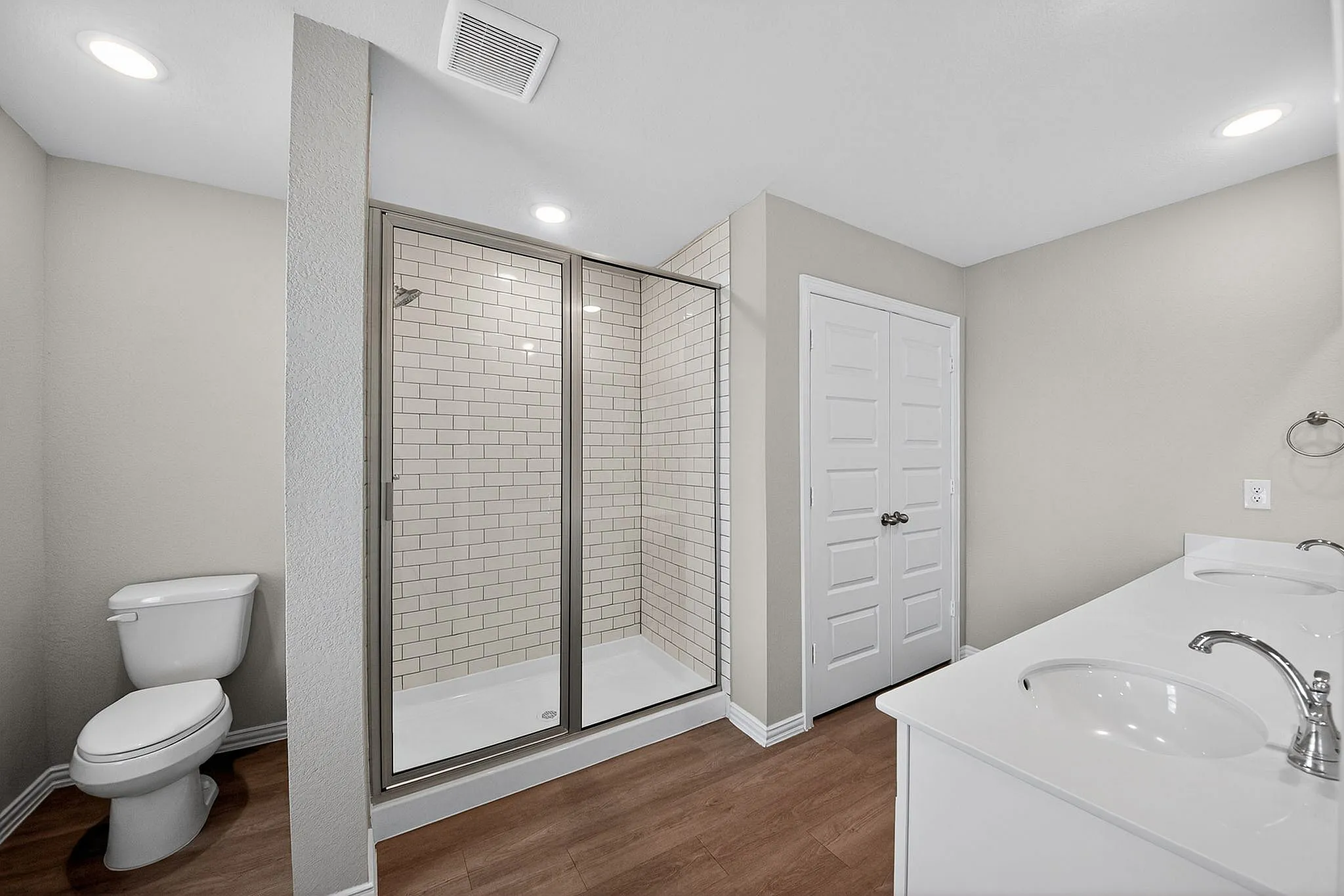 large bathroom with extra closet and walk-in shower