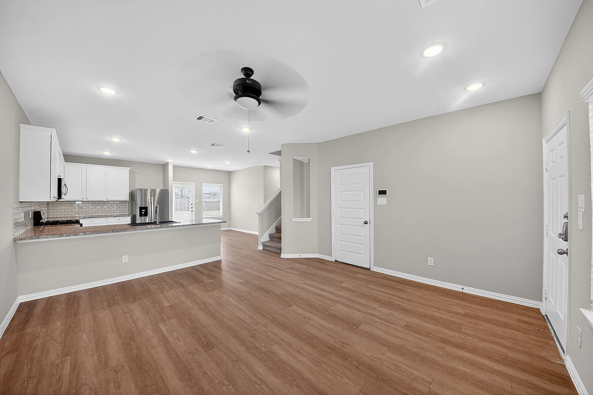 living room with wood style flooring and ceiling fan