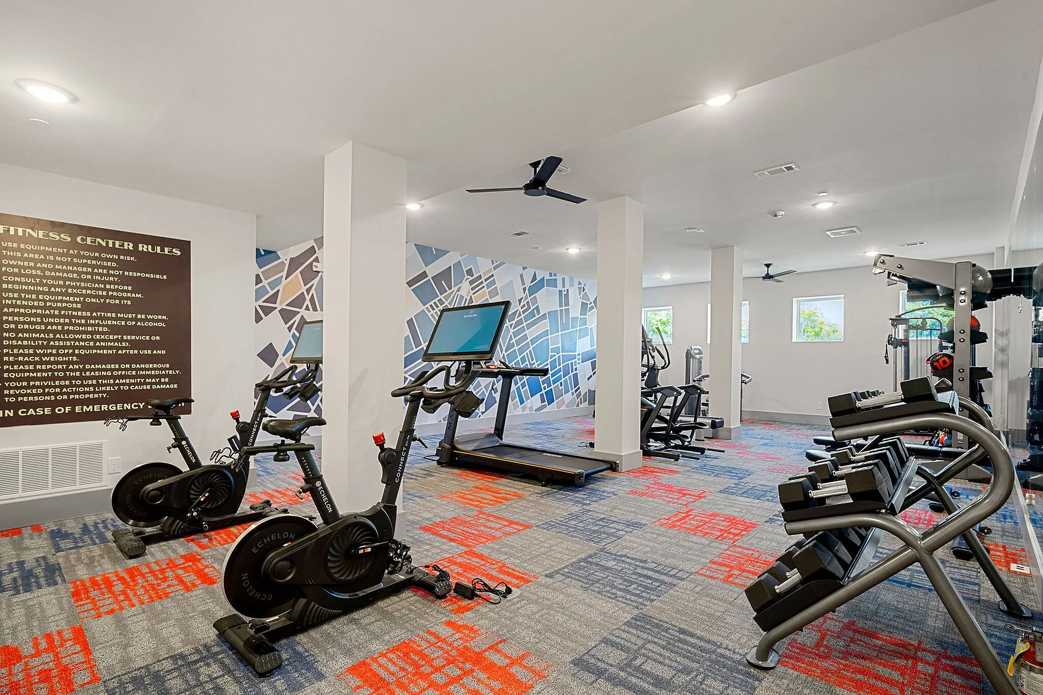 fitness center with cardio equipment and free weights