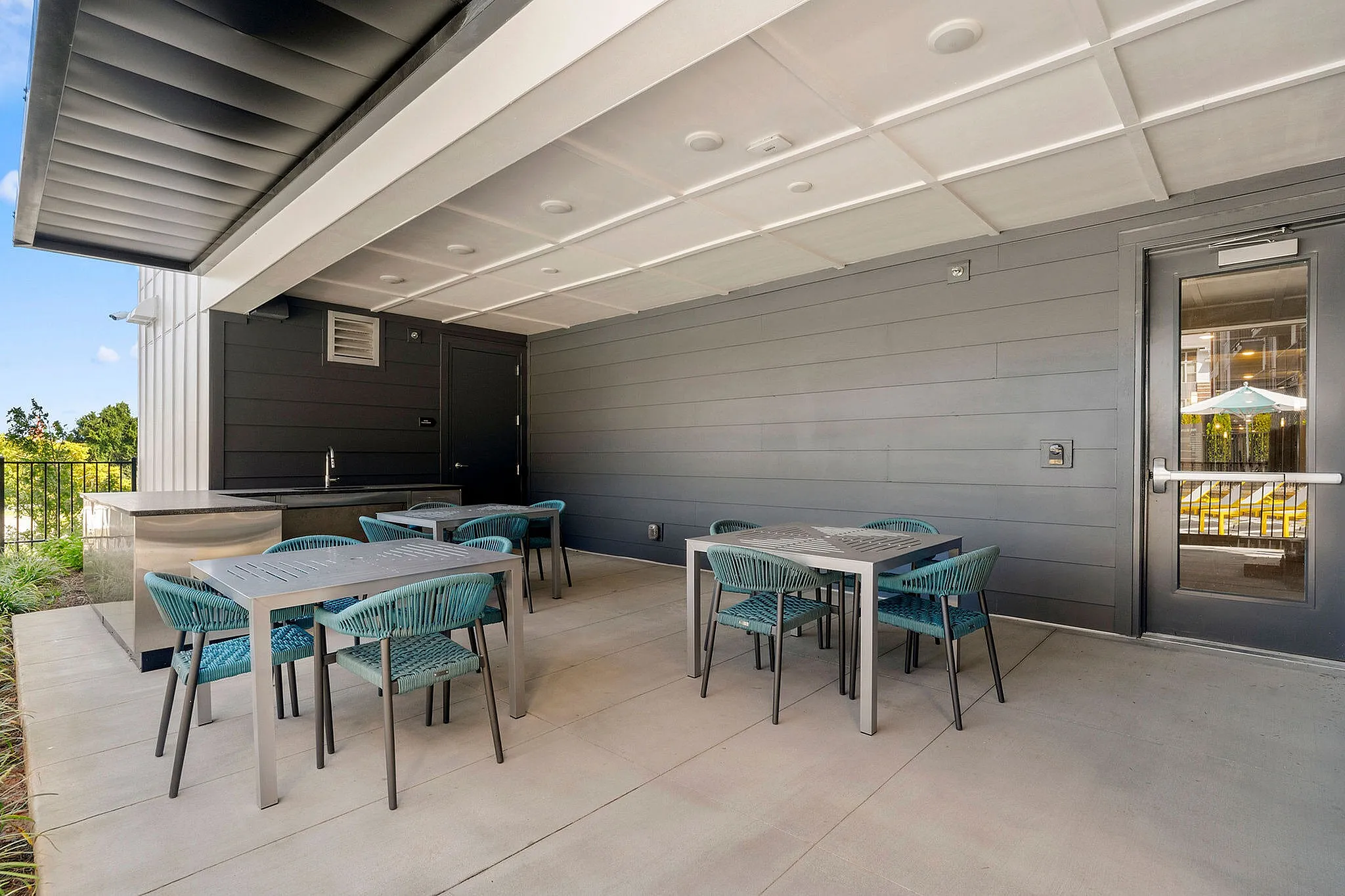 poolside kitchen with dining tables