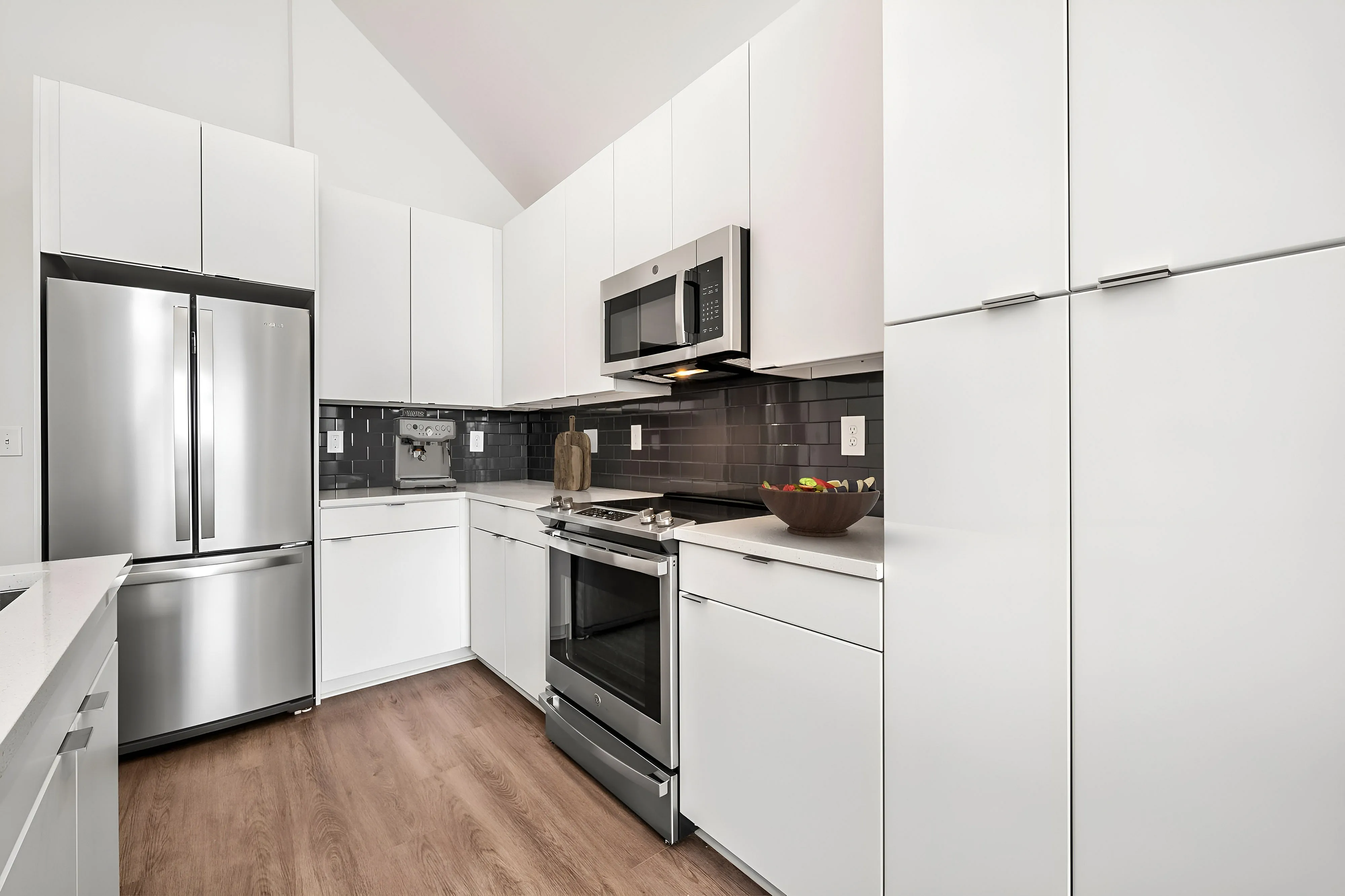 modern kitchen with white cabinetry and tile backsplash
