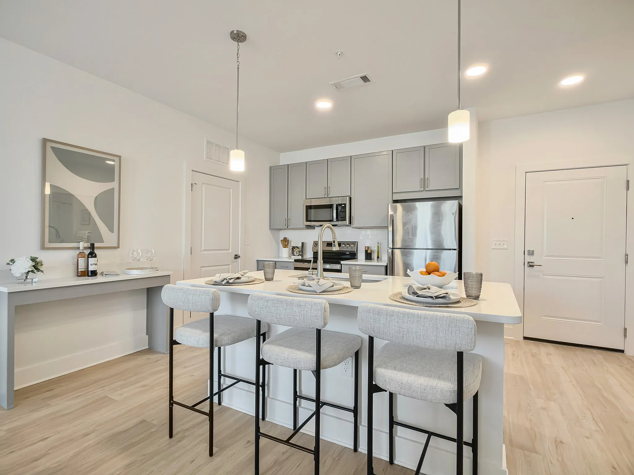 modeled kitchen with island seating and stainless steel appliances
