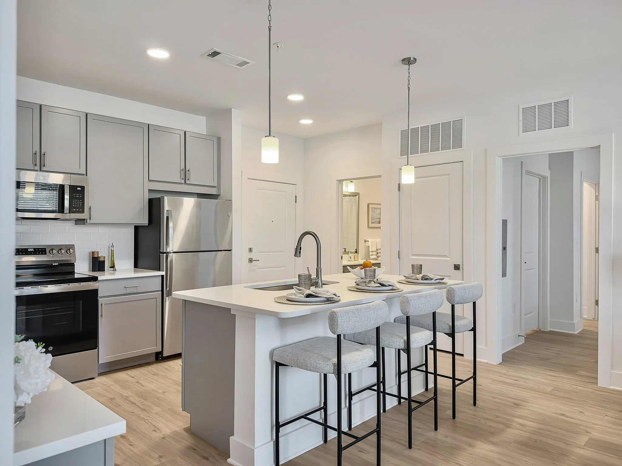 modeled kitchen with stainless steel appliances and island seating