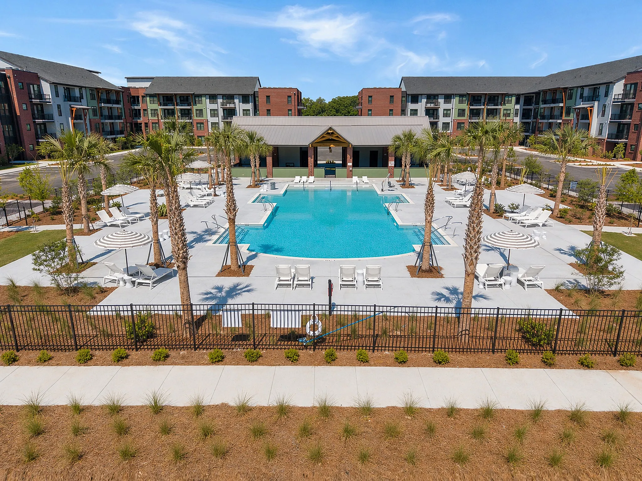 large swimming pool with seating and umbrellas