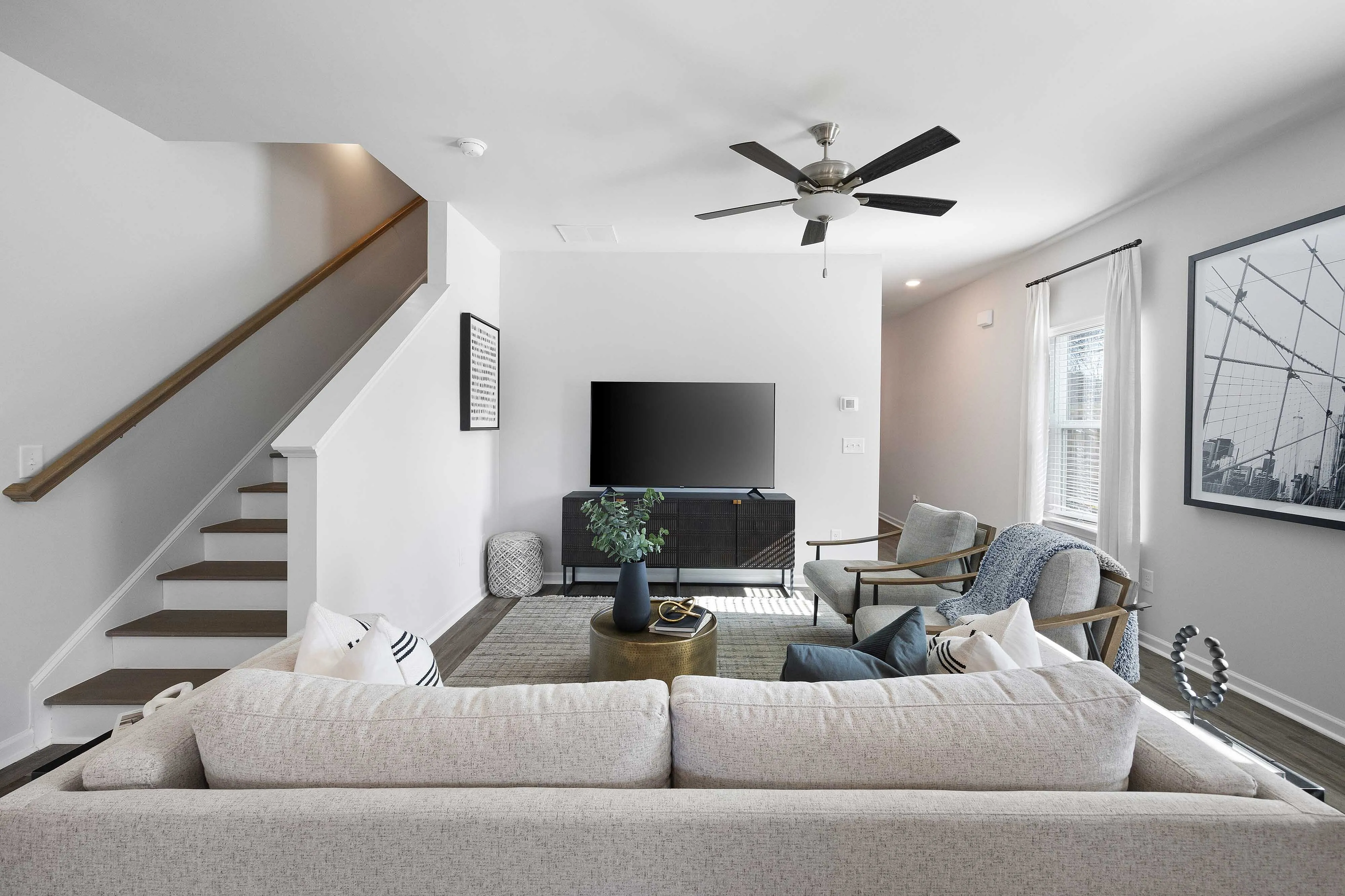 modern furnished living area next to staircase