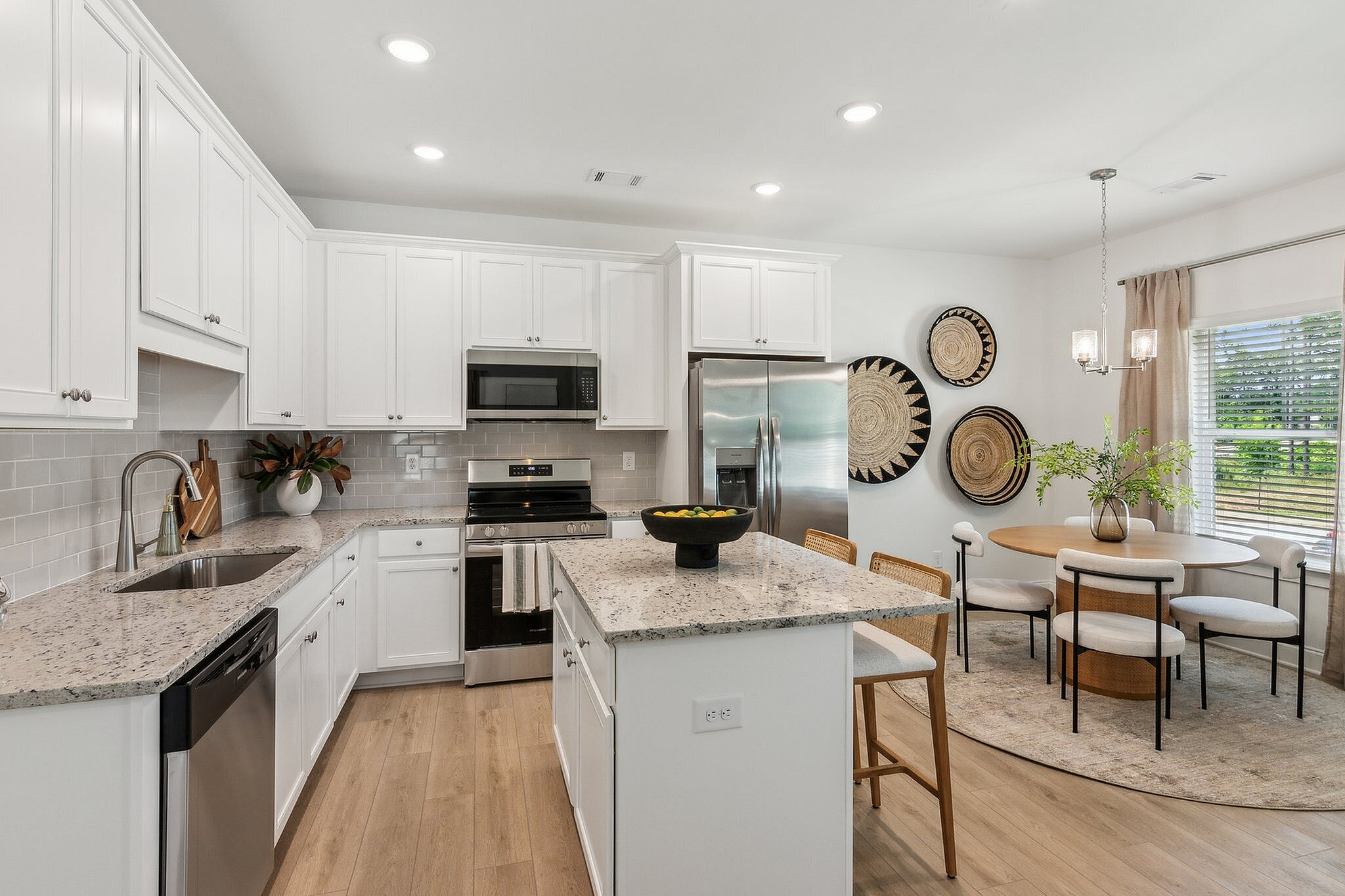modeled kitchen with stainless steel appliances and dining table