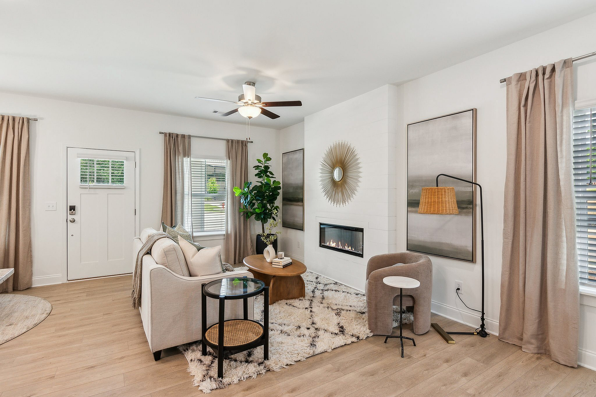 modeled living room with couches and tables with a fireplace