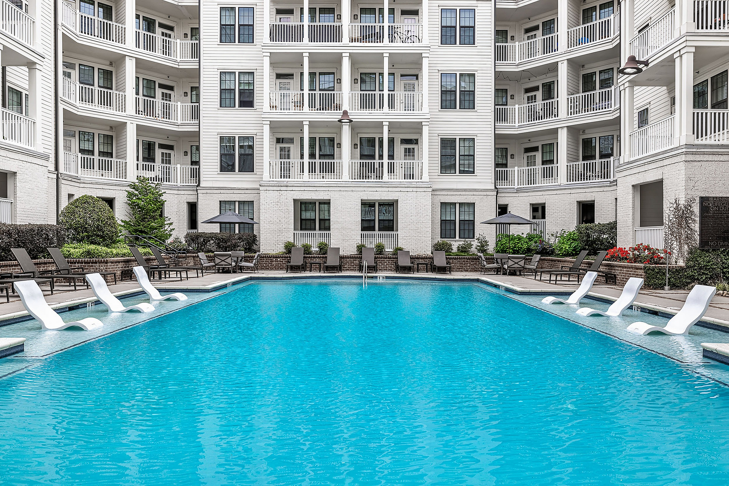 Swimming pool with sundeck and lounge chairs