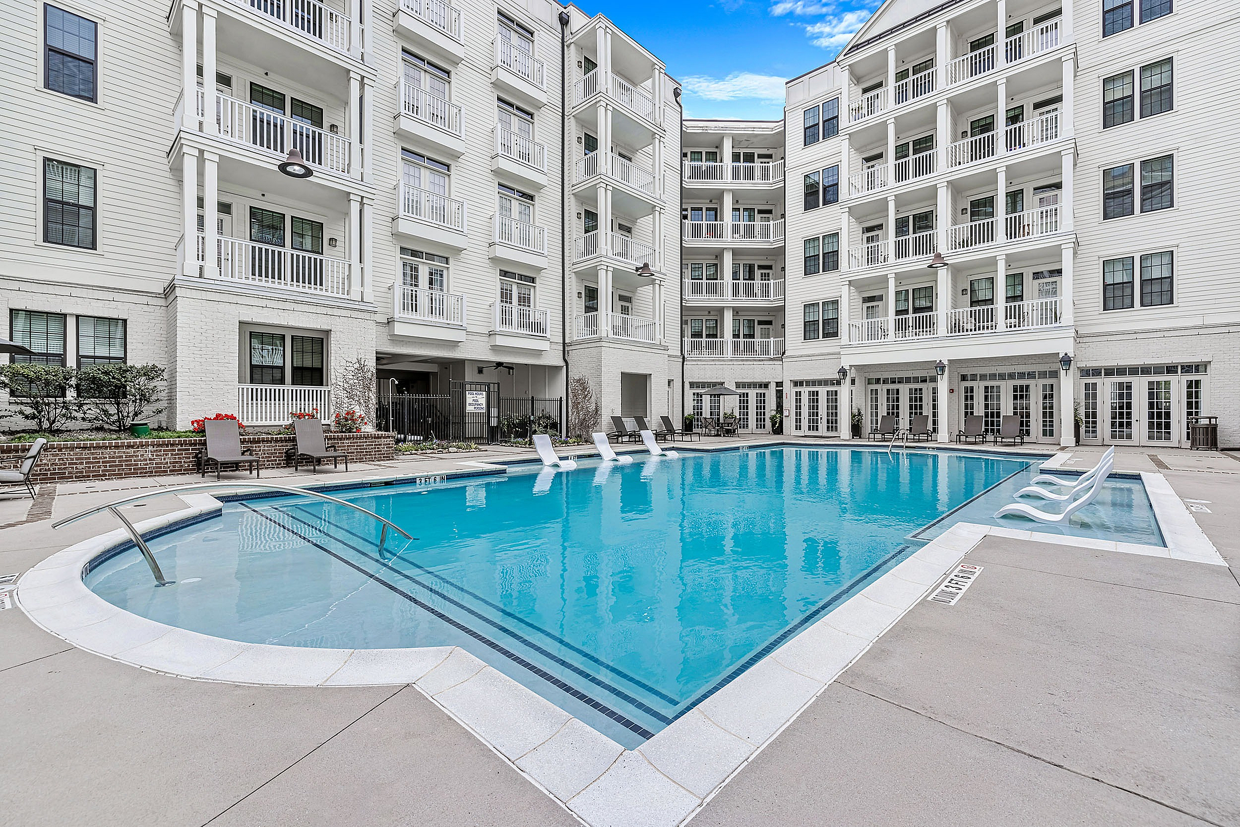 Swimming pool with sundeck and lounge chairs