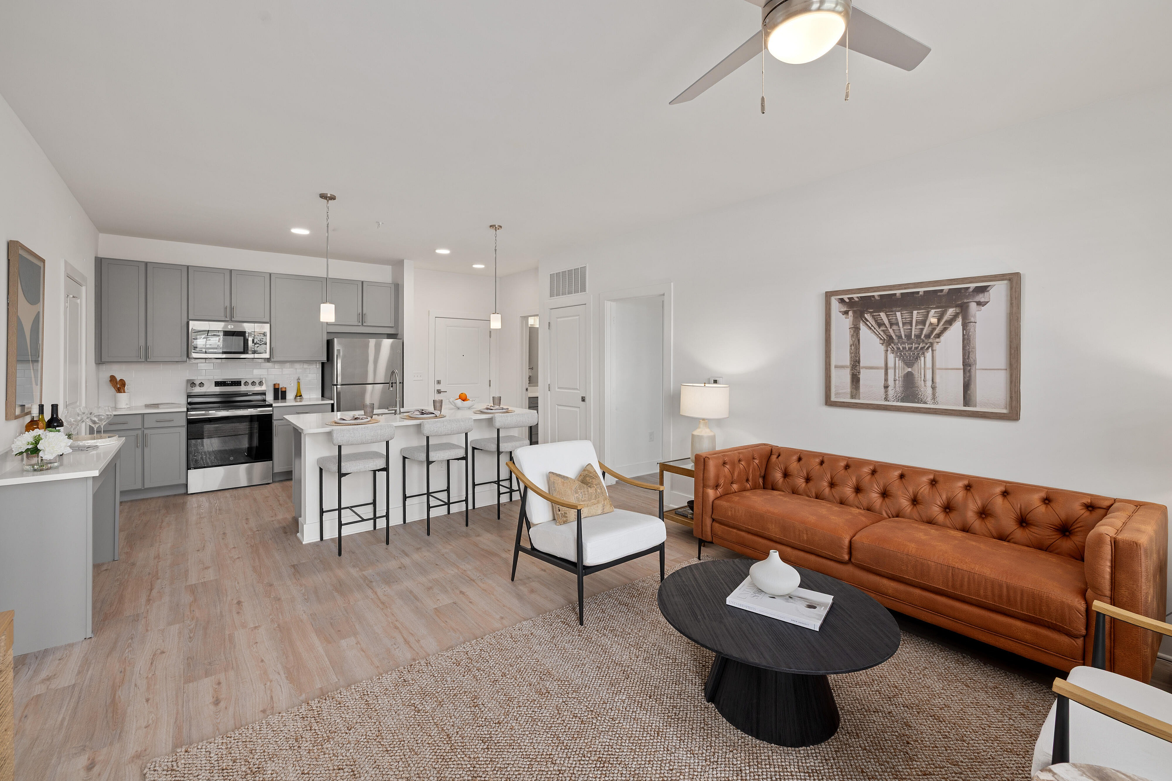 interior of home with leather couch and kitchen island