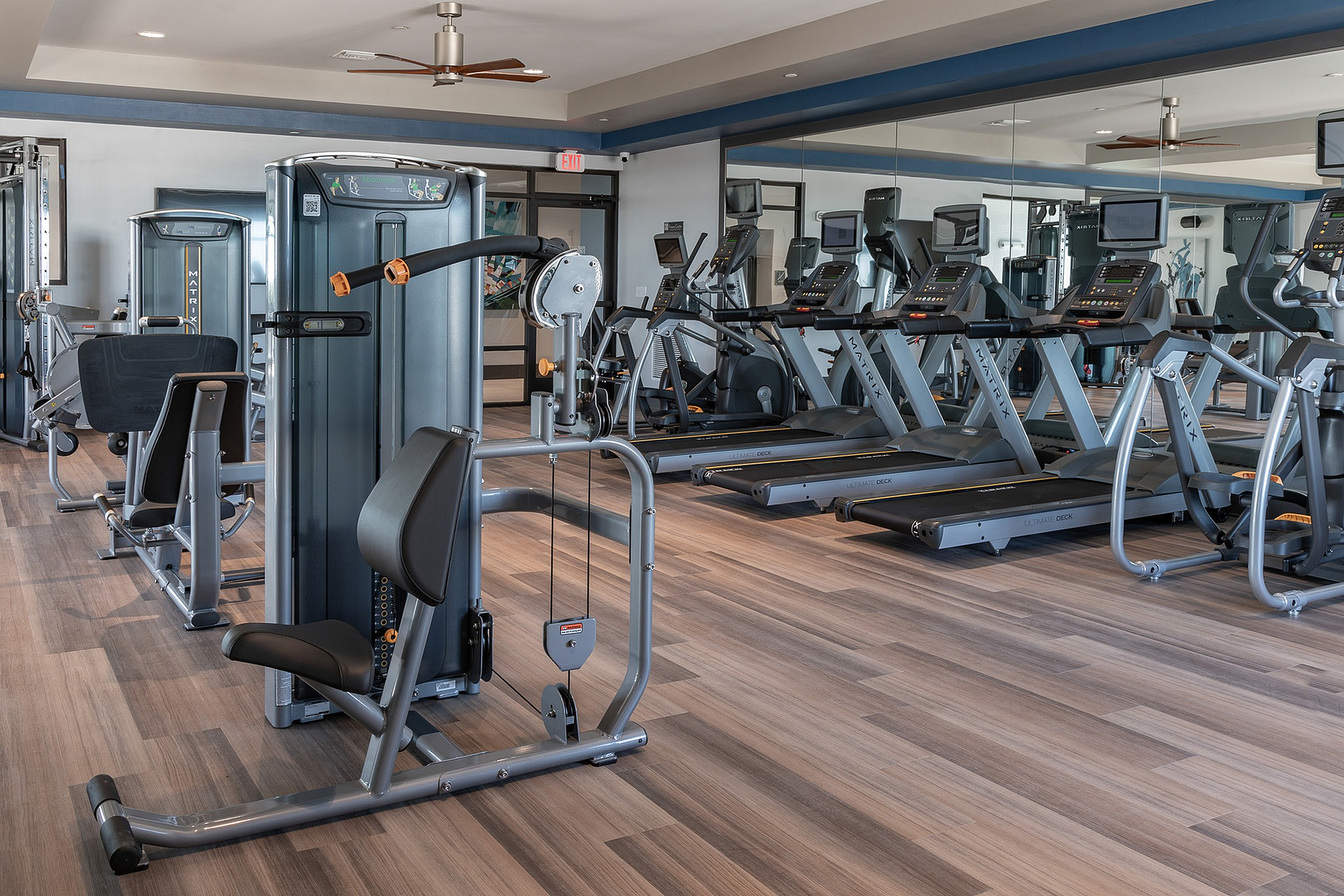 Modern fitness center with high-end treadmills, strength machines, and a sleek, spacious design for optimal workouts.