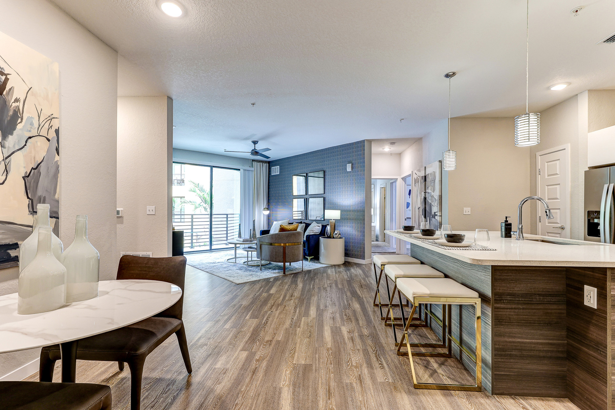 Modern open-concept apartment featuring a stylish kitchen island, elegant dining area, and inviting living room with ample natural light.