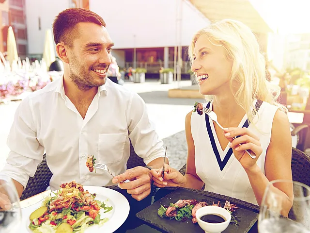 man and woman eating lunch outdoors