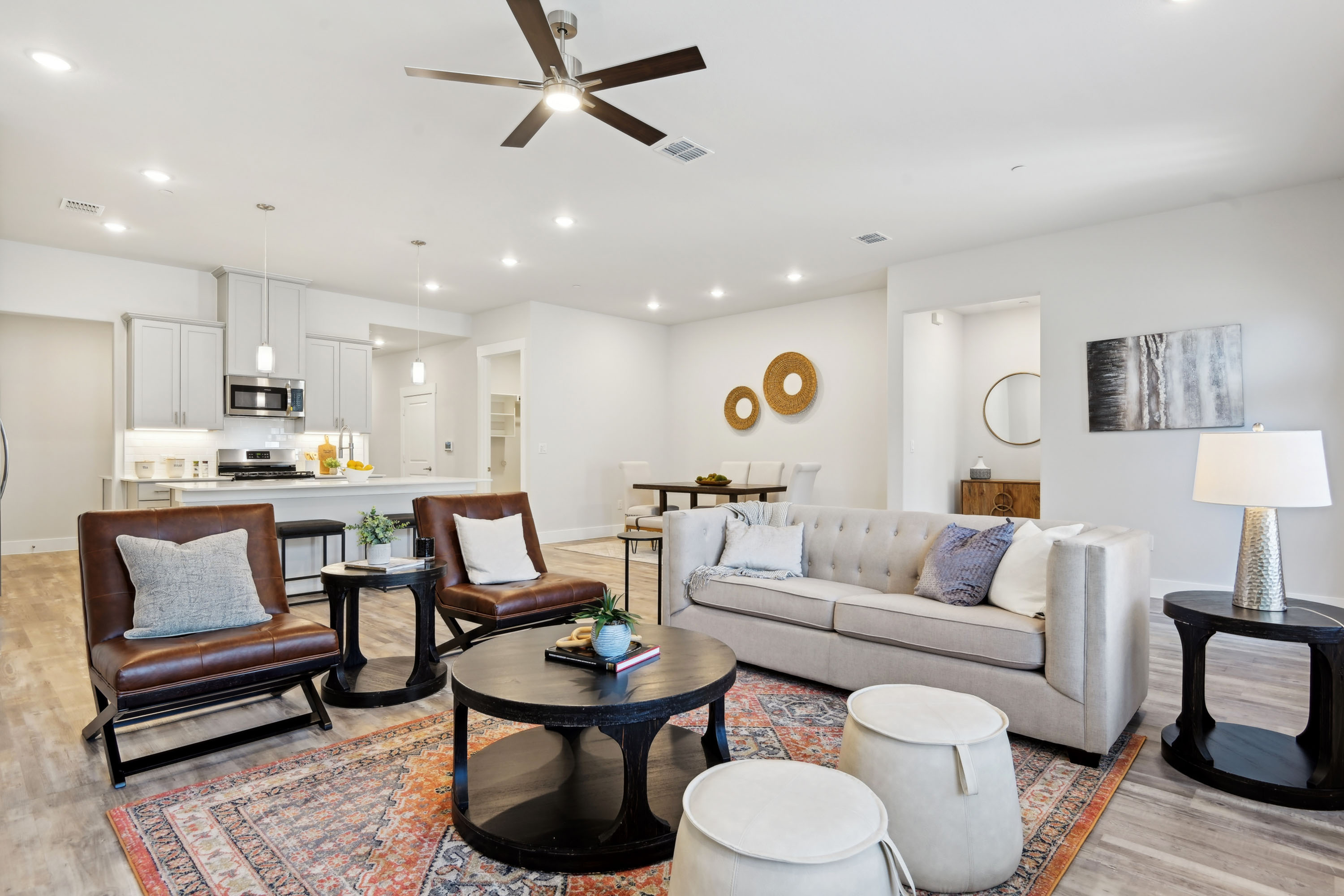 Furnished living area with vaulted ceilings next to upscale kitchen
