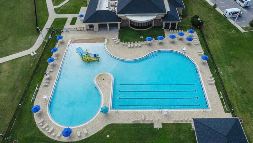 aerial shot of pool and clubhouse in daytime