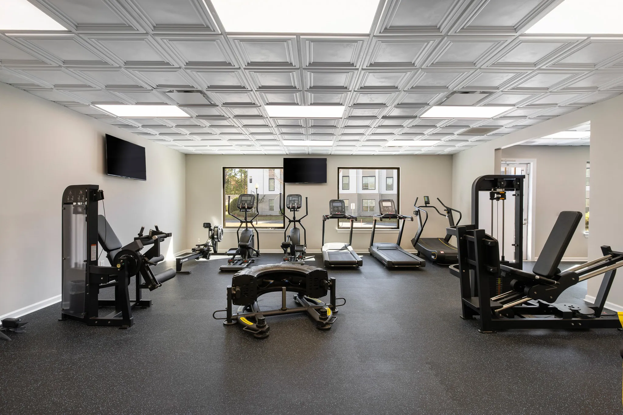 24/7 hour fitness center with treadmills and equipment