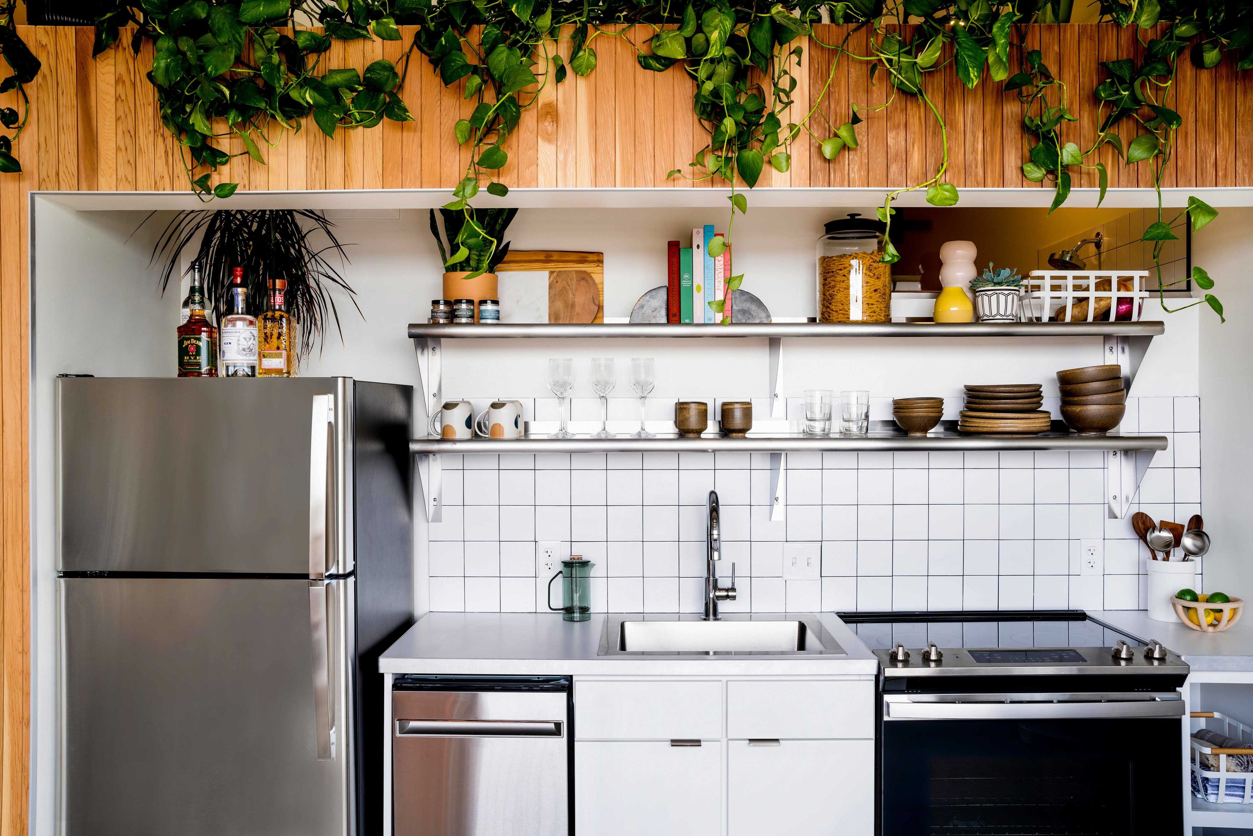 modern kitchen with tile backsplash and stainless steel appliances