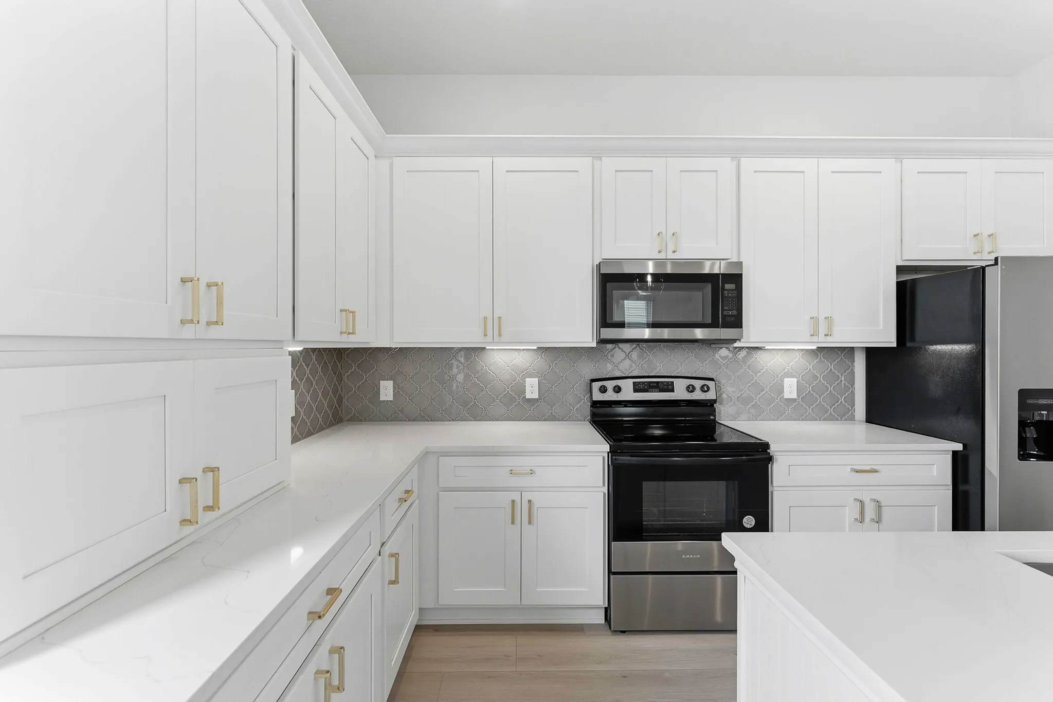 backsplash in kitchen with upgraded appliances