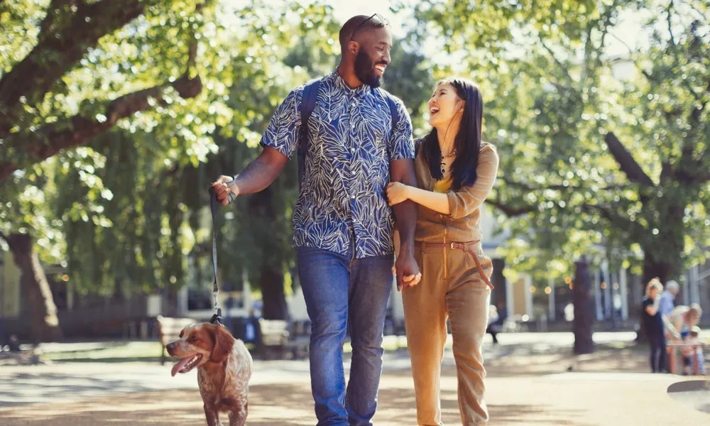 man walking dog in park area