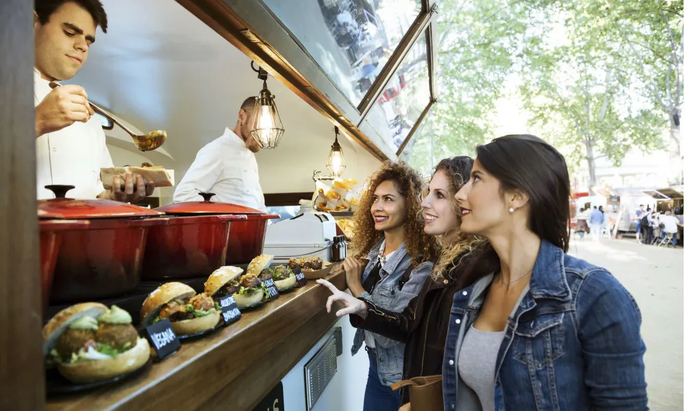 women at food truck ordering food