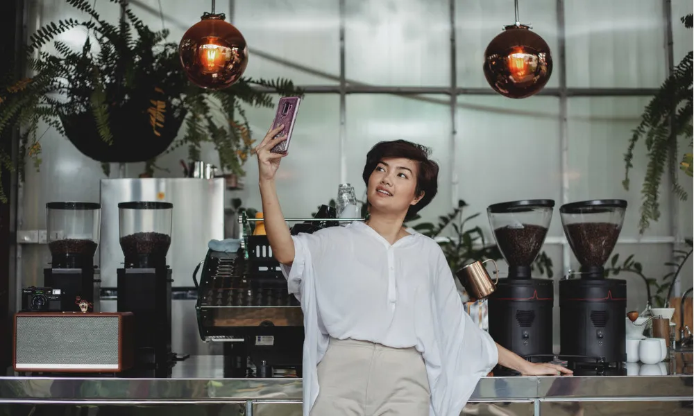woman taking selfie in coffee shop