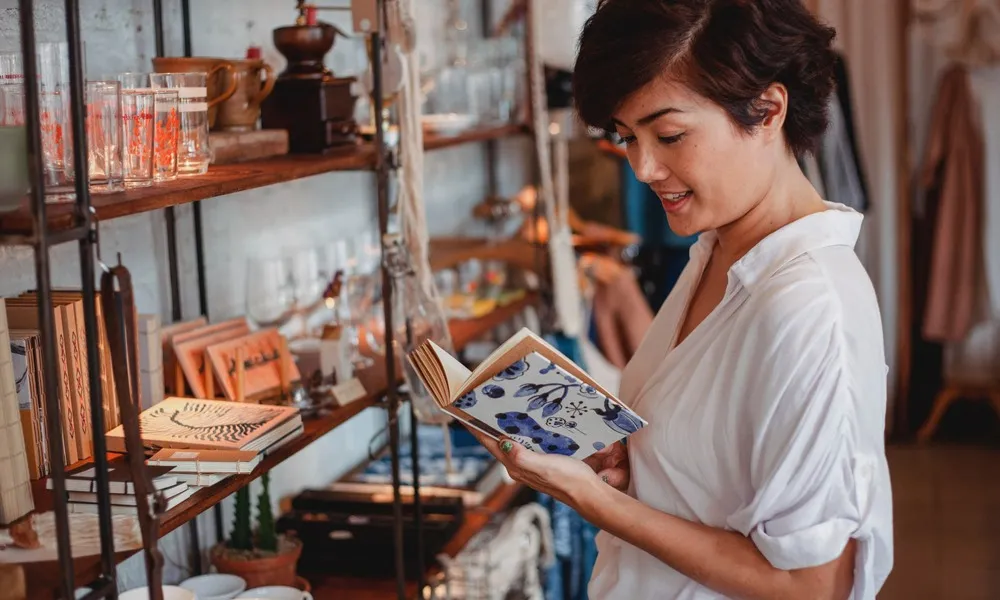 woman looking at item in shop