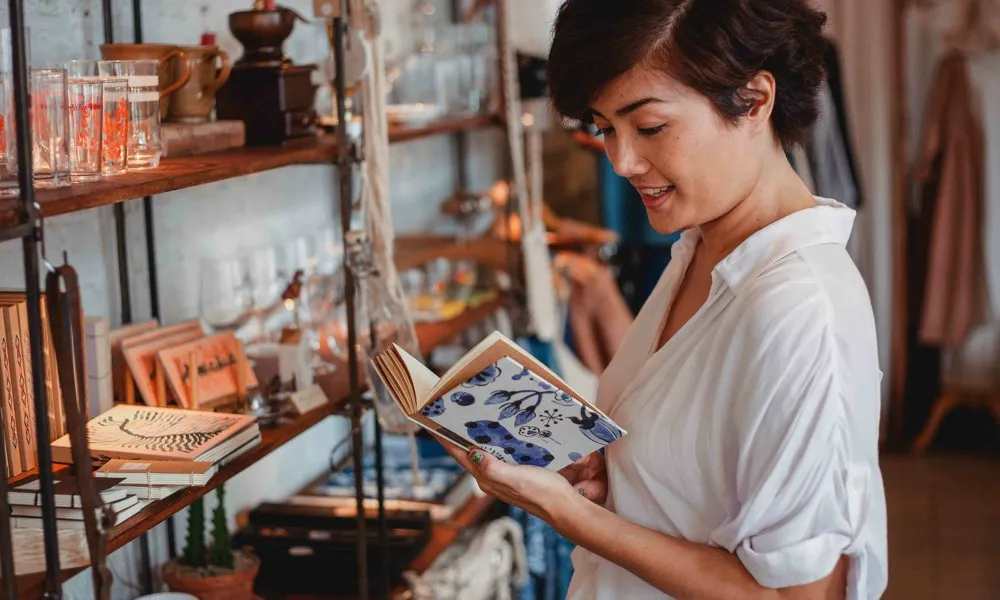 girl looking at book in a shop
