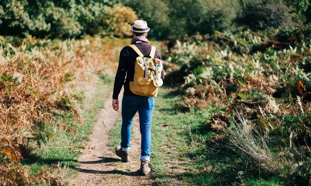 stylish man walking on trail