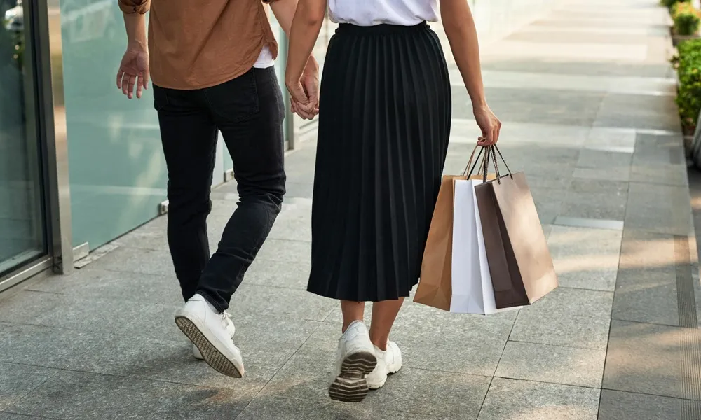 couple holding hands outdoors shopping
