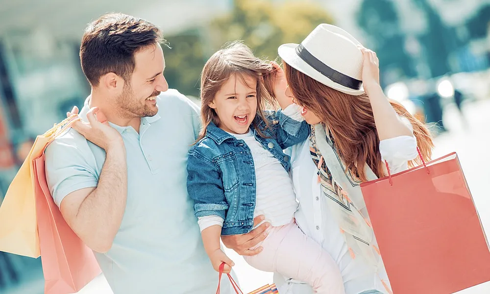 Joyful family with shopping bags enjoying a day out.