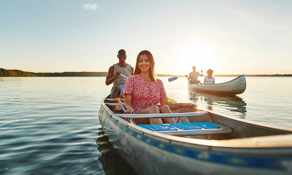 man and woman in a canoe in a body of water