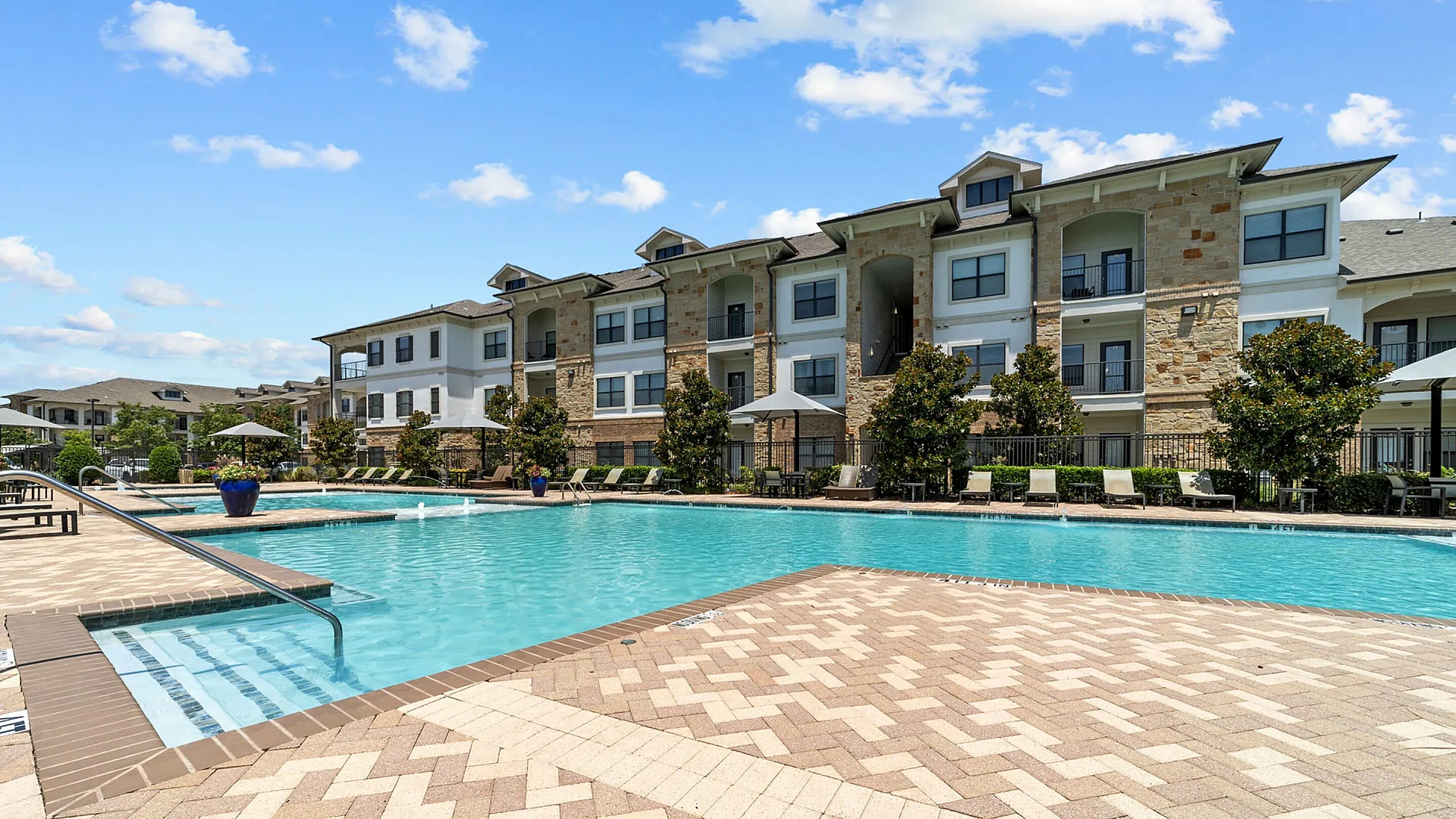 community pool with lounge chairs