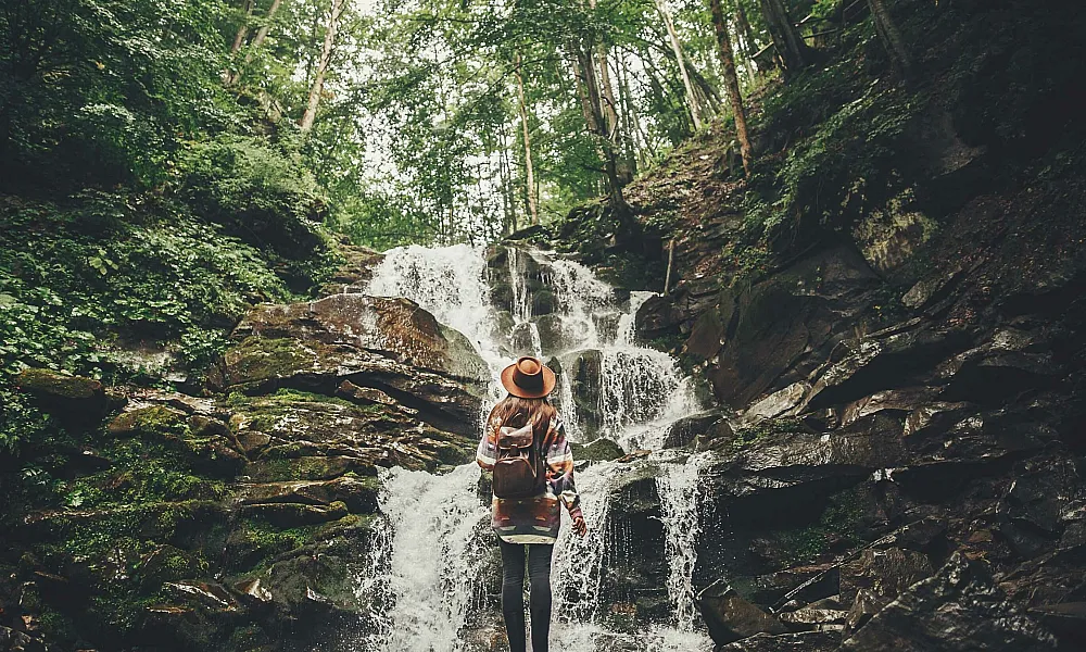 Woman in front of a waterfall