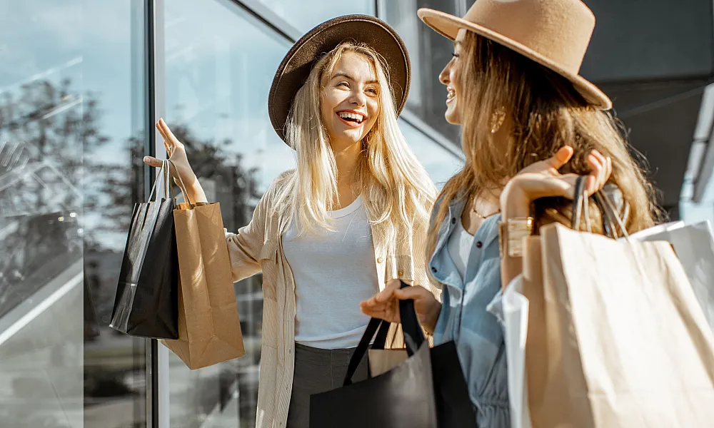 two women in stylish hats shopping