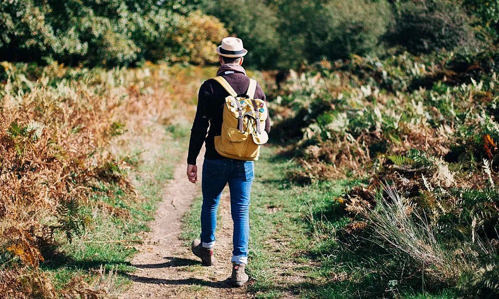 man walking on trail