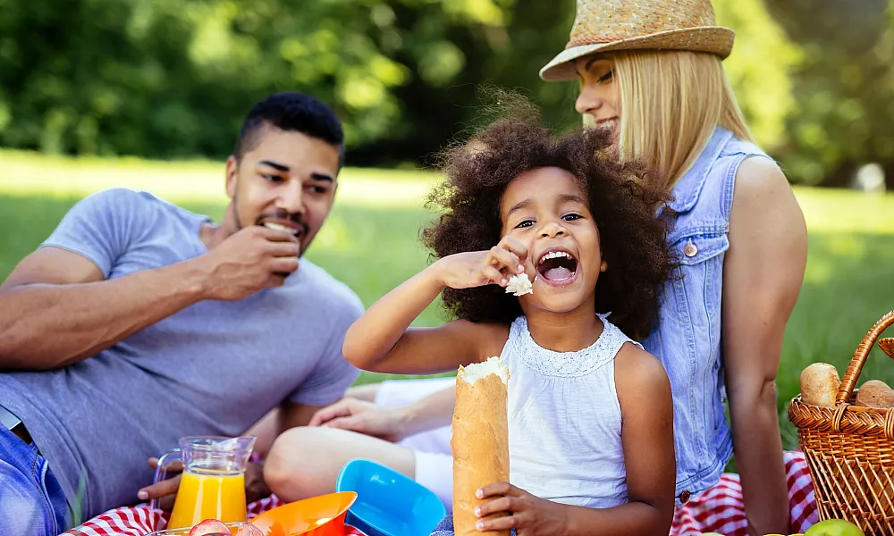 young family enjoying a picnic in the park
