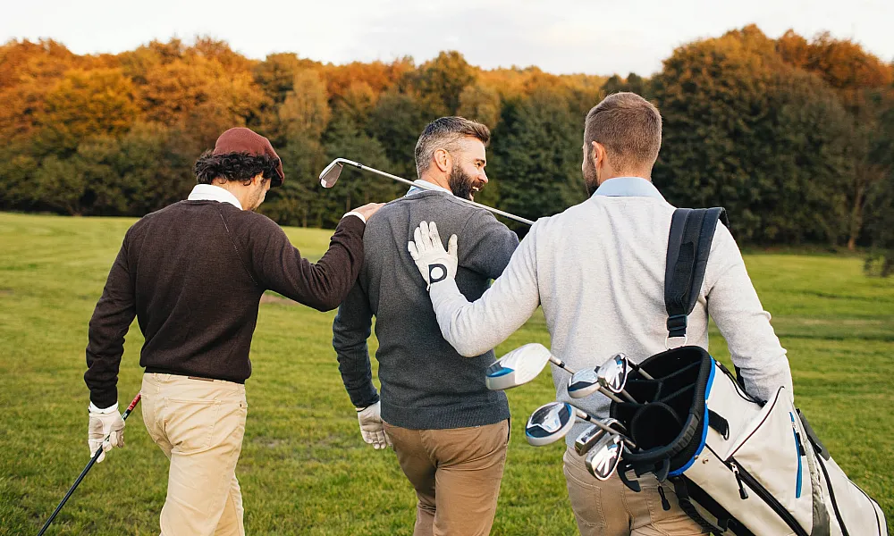 three men on a golf course
