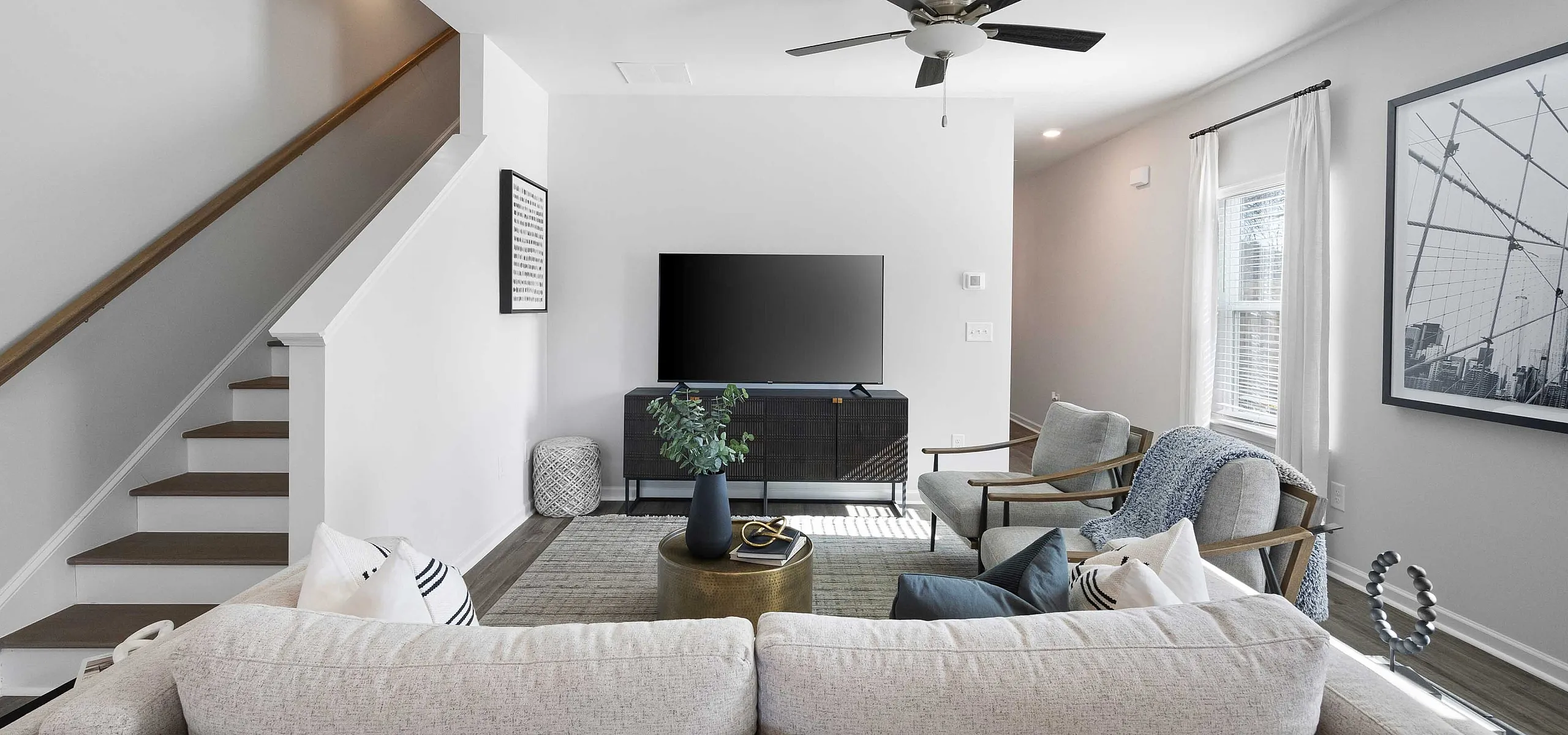 modern furnished living area next to staircase