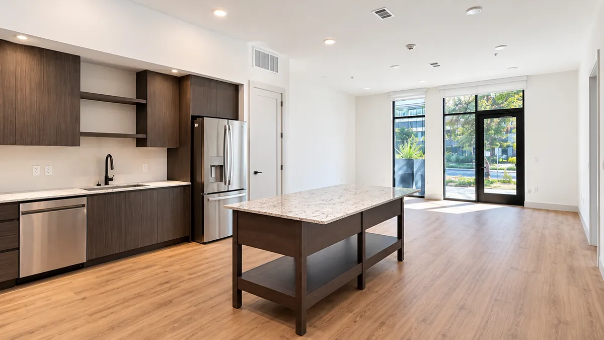 Concept image of a Live/Work space with an open kitchen, island and room to host clients