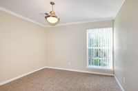 Bright and airy room with elegant lighting and plush carpeting, perfect for creating a cozy atmosphere.