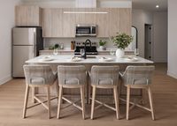 Modern apartment kitchen with island seating, light wood cabinets, stainless appliances, and decor.