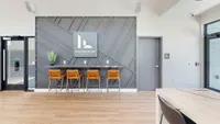 Modern lobby of Foundry Flats Apartments featuring stylish seating and a geometric wall design.