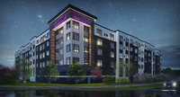 Luxurious apartment building with modern architecture, illuminated at night under a starry sky, featuring lush landscaping and stylish design.