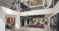 Luxurious apartment lobby with elegant lounge area, contemporary lighting fixtures, and modern artwork, offering a welcoming and stylish ambiance.
