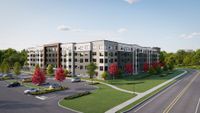 Modern apartment complex with sleek design, surrounded by lush greenery and vibrant red trees, featuring ample parking and a peaceful suburban setting.