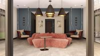 Chic lounge area with modern suspended chairs, stylish lighting, and cozy red couches in a contemporary setting.
