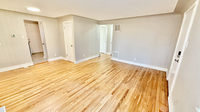 Bright and spacious room showcasing elegant hardwood flooring and modern doors, ideal for stylish living.