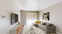 Chic living room with contemporary decor, featuring a plush gray sofa, vibrant yellow accents, and a stylish wall art centerpiece.