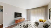 Contemporary living room with a sleek wall-mounted TV, stylish wooden cabinet, and bright natural light from tall vertical blinds.