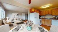 Inviting open-concept living area with modern kitchen, cozy seating, and stylish decor.
